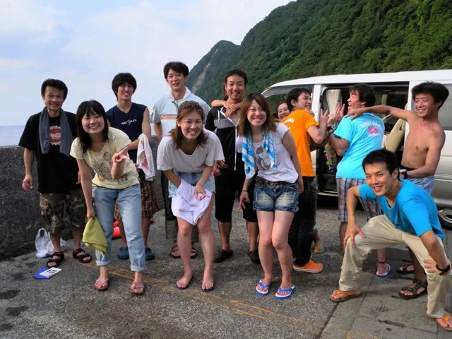 海辺で記念撮影するBIG BLUEの参加者（2012-2013年）