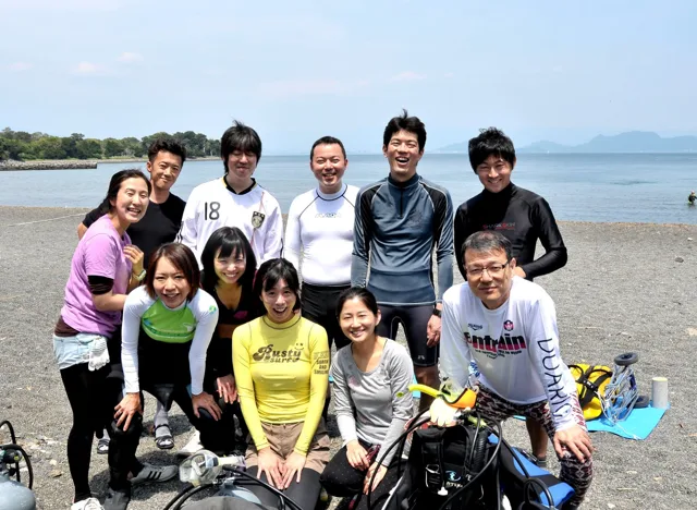 海辺で記念撮影するBIG BLUEの参加者（2012-2013年）