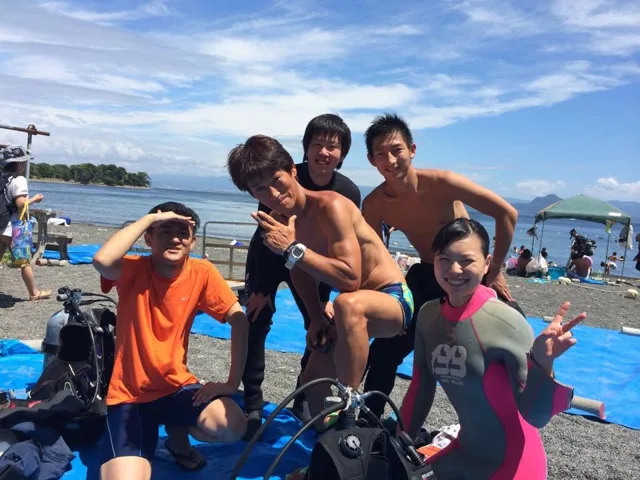 海辺で記念撮影するBIG BLUEの参加者（2014年）