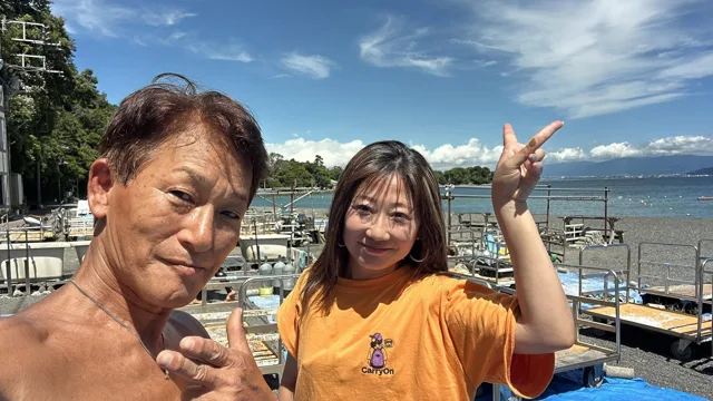 伊豆・大瀬崎でのダイビング:大瀬崎の海岸で記念撮影する二人