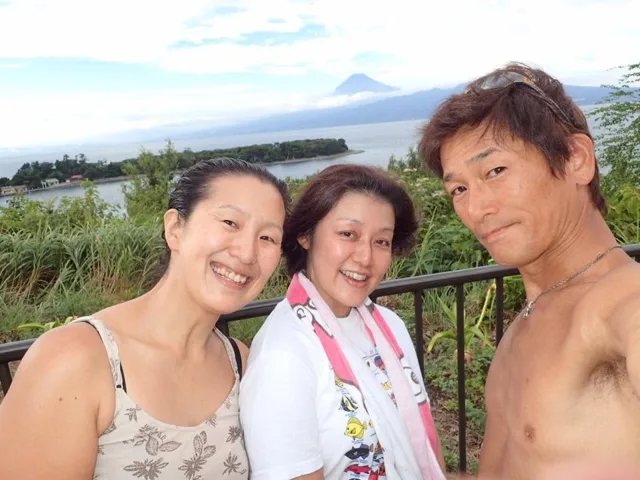 伊豆・大瀬崎（景観からの推定）でのダイビング：富士山と海を背景に記念撮影するダイビング仲間